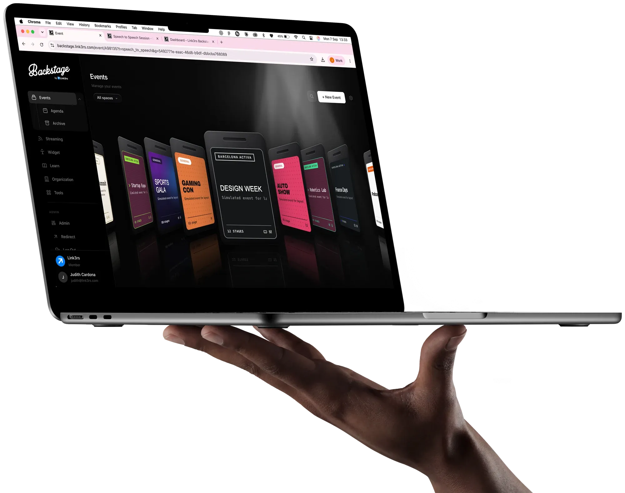 A laptop held in one hand, with Backstage open on the events list